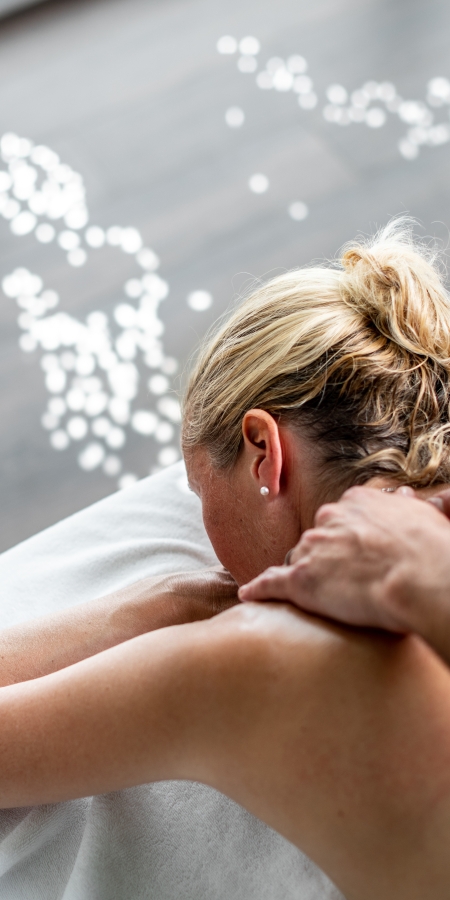 A therapist massages the back of a client A therapist massages the back of a client