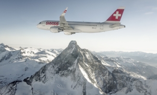 Plane flies over the Swiss Alps in winter Plane flies over the Swiss Alps in winter